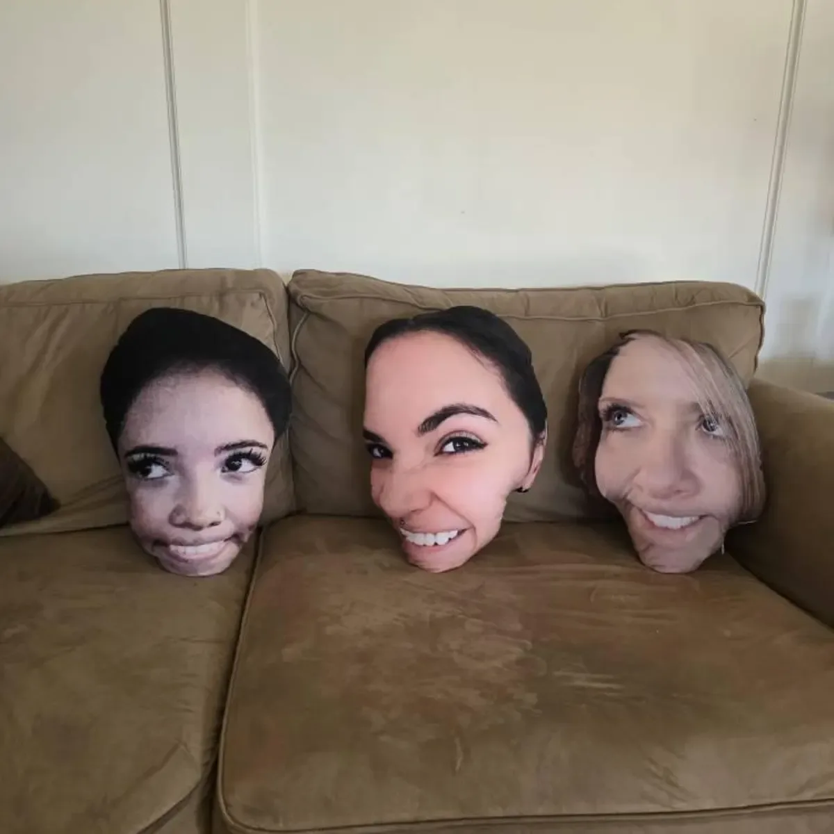 Custom face pillows on a sofa
